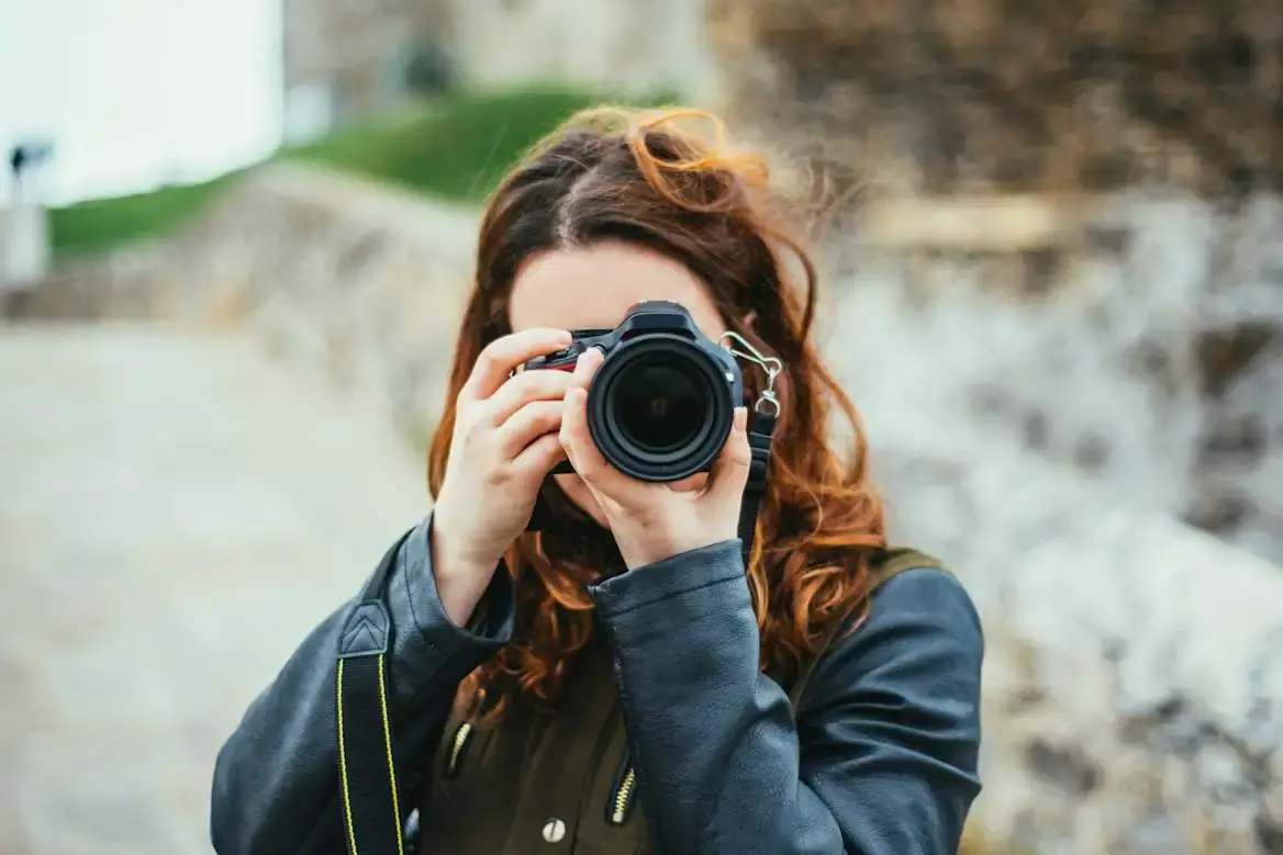 A photographer looking through their camera