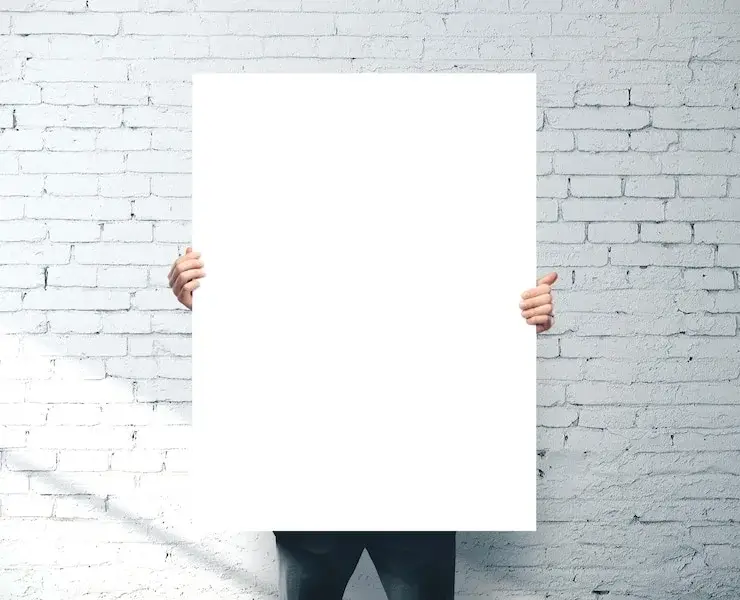 A poster being carefully unrolled on a clean surface